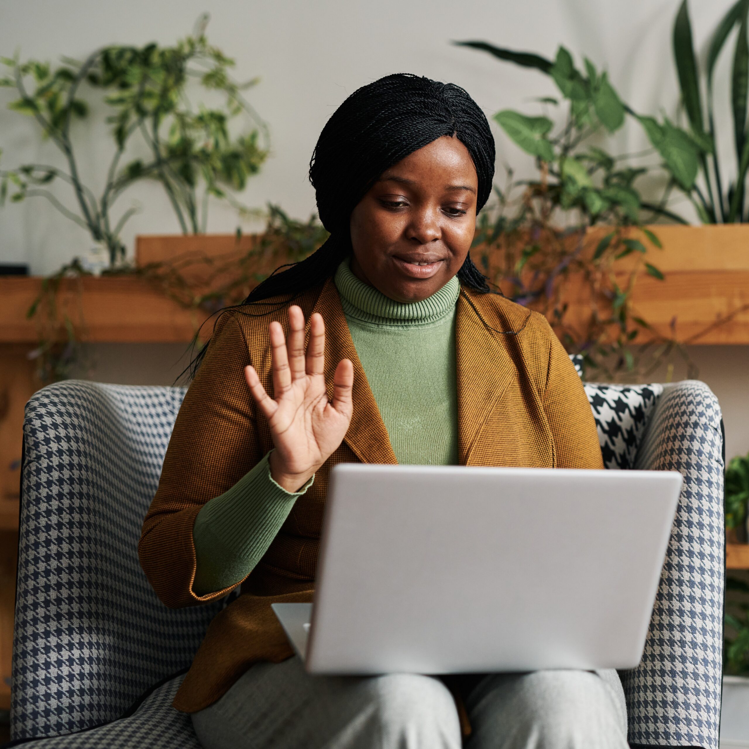 happy-young-black-woman-waving-hand-patient-online-session